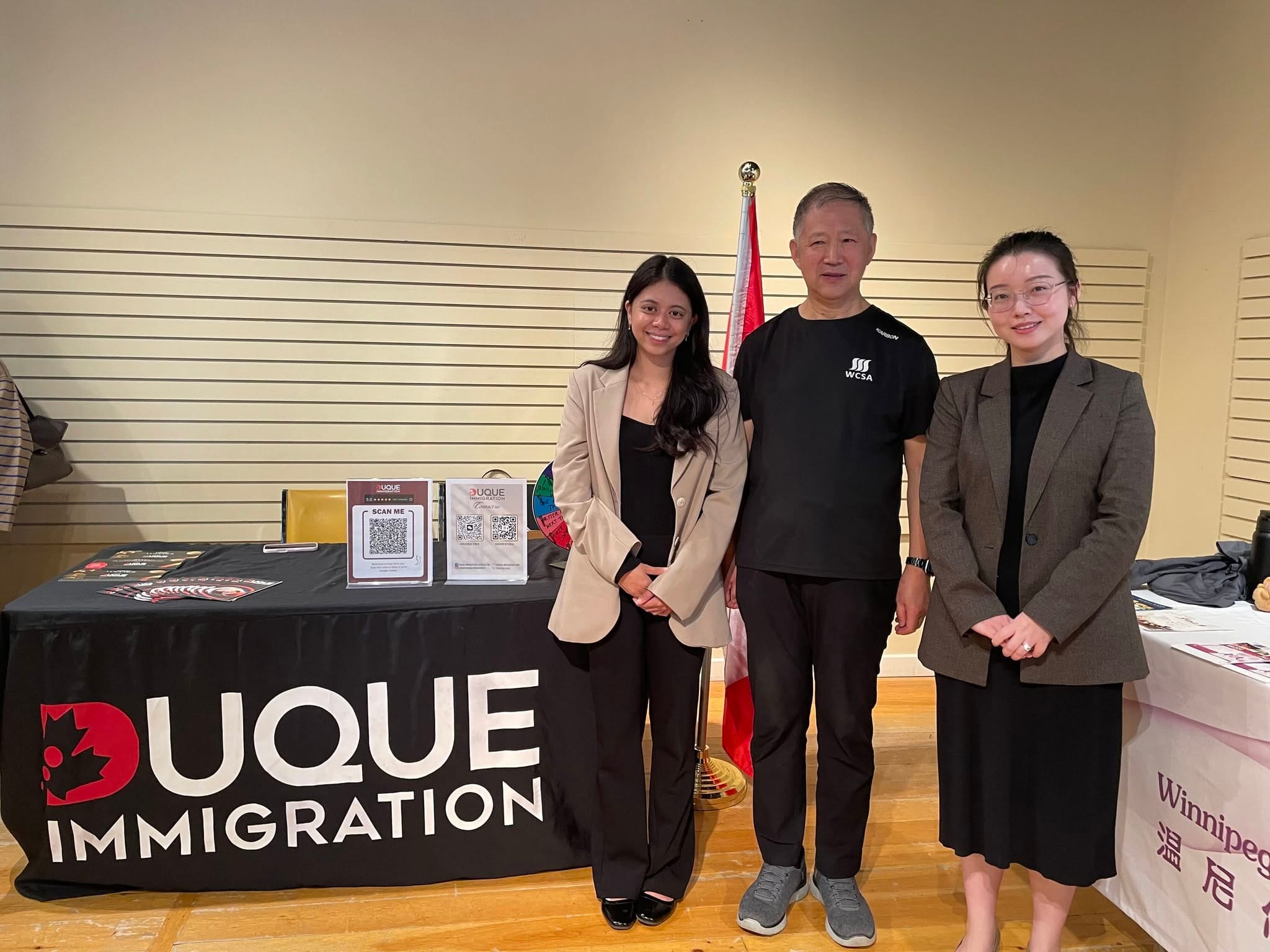 Duque Immigration team speaking with attendees