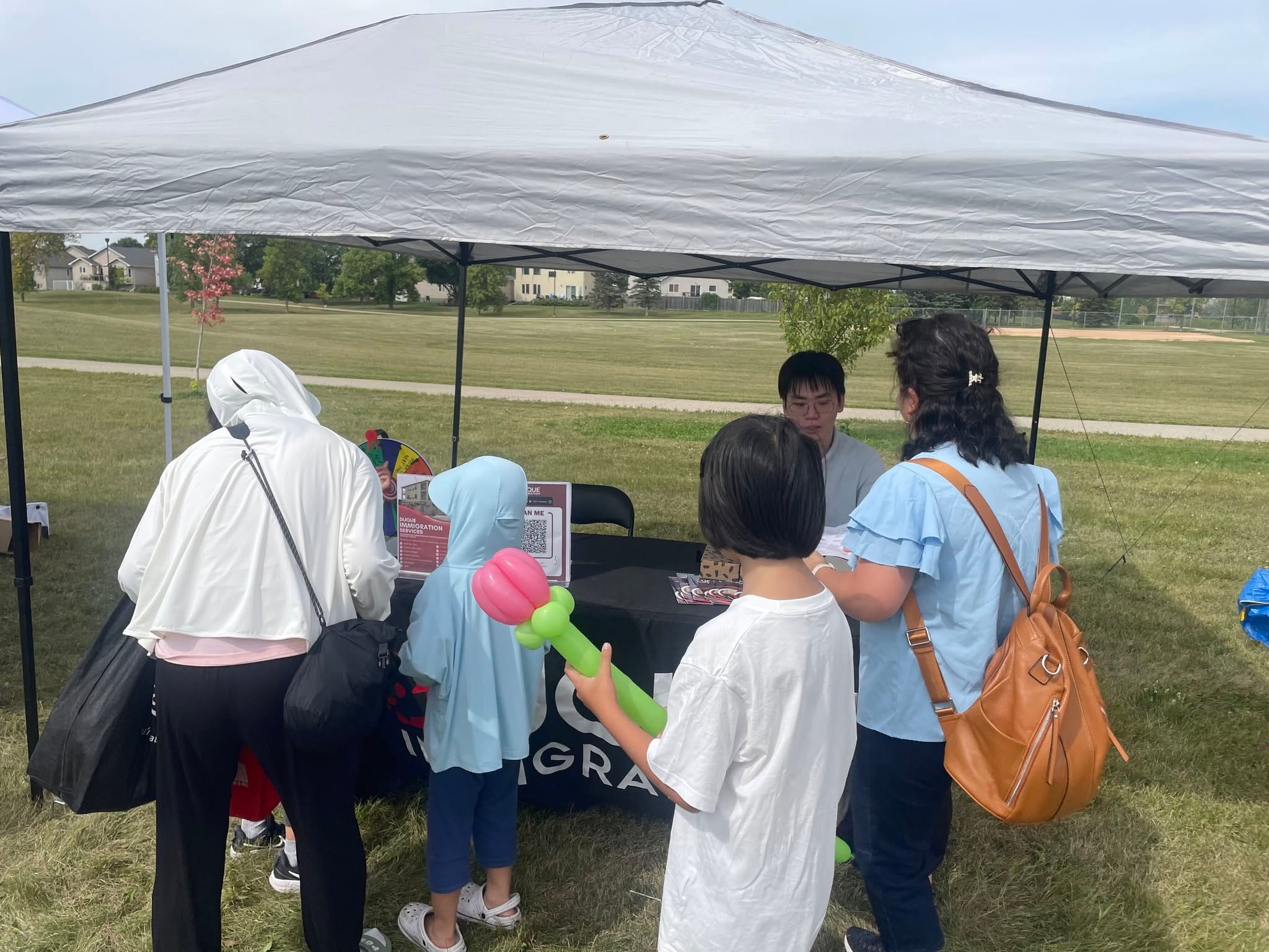 Duque Immigration team chatting with newcomers and their families